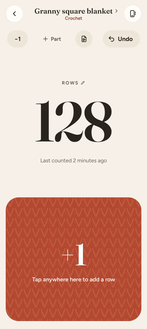 The counter of a crochet project at 128 rows, with a large +1 target.